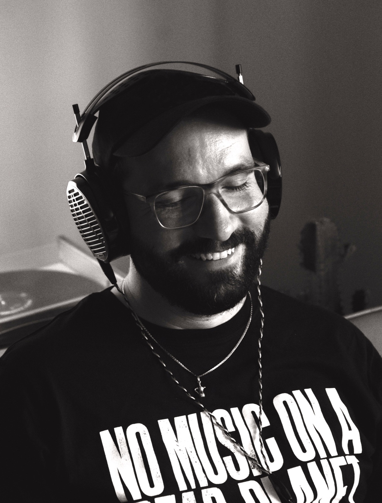 Flo Siller with his eyes closed, wearing open headphones