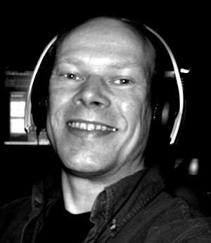 Helge Ohlenbostel wearing headphones in his studio