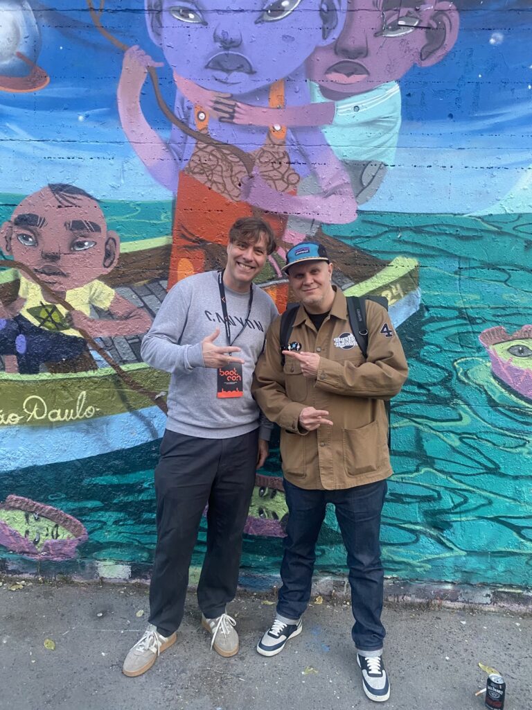 Frank Hahn with DJ Hype in front of a mural on the RAW site in Berlin